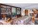 Cozy living room with a television, built-in bookshelves, and comfortable seating adjacent to dining at 12565 Sheridan Blvd # 105, Broomfield, CO 80020