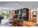 Bright living room with a built-in bookshelf, balcony, hardwood floors, and comfortable seating at 12565 Sheridan Blvd # 105, Broomfield, CO 80020