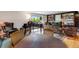 Spacious living room with a piano, dining area, and comfortable seating, perfect for entertaining at 12565 Sheridan Blvd # 105, Broomfield, CO 80020