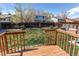 View of the backyard from the deck, featuring a well maintained lawn, a privacy fence, and mature trees at 8463 Wheatgrass Cir, Parker, CO 80134