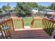 A nicely landscaped back yard with a wooden fence seen from a small deck at 8463 Wheatgrass Cir, Parker, CO 80134