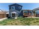 Backyard view with a patio, deck, lush lawn, and privacy fence, perfect for outdoor enjoyment at 8463 Wheatgrass Cir, Parker, CO 80134
