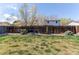 Spacious backyard with a well-maintained lawn, rock garden, and privacy fence at 8463 Wheatgrass Cir, Parker, CO 80134