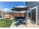 Outdoor patio area features a table and chairs with umbrella, perfect for entertaining at 8463 Wheatgrass Cir, Parker, CO 80134