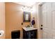 Charming half bath with dark wood vanity and decorative mirror at 8463 Wheatgrass Cir, Parker, CO 80134
