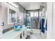 Bright bathroom features a glass shower and unique blue glass sink bowl at 8463 Wheatgrass Cir, Parker, CO 80134