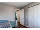Bedroom with wood floors offers closet space and an open doorway at 8463 Wheatgrass Cir, Parker, CO 80134