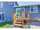 Wooden deck and stairs that lead from the backyard up to the house and sliding glass door at 8463 Wheatgrass Cir, Parker, CO 80134