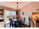 A dining area with a round wooden table, four chairs, and sliding door access to the backyard at 8463 Wheatgrass Cir, Parker, CO 80134