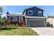 Two-story home boasts a two-car garage, manicured lawn, and a charming deck, perfect for enjoying the outdoors at 8463 Wheatgrass Cir, Parker, CO 80134