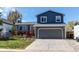 Two-story home with a gray exterior, attached garage, and a front yard with a wood deck at 8463 Wheatgrass Cir, Parker, CO 80134