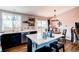 Open kitchen area featuring a white island with seating, stainless appliances, and a dining area with sliding door access at 8463 Wheatgrass Cir, Parker, CO 80134