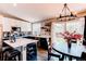 Bright kitchen and dining area with stainless steel appliances, large island, and sliding glass doors to the deck at 8463 Wheatgrass Cir, Parker, CO 80134