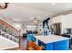 A modern kitchen flows to a living room with an island, stainless steel appliances, and hardwood floors at 8463 Wheatgrass Cir, Parker, CO 80134