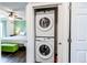 Convenient laundry closet features a stacked Samsung washer and dryer unit at 8463 Wheatgrass Cir, Parker, CO 80134