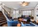 Cozy living room featuring a staircase and comfortable seating, creating a warm and inviting space to relax at 8463 Wheatgrass Cir, Parker, CO 80134