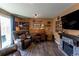 Cozy living room with wood floors and fireplace offers comfortable seating at 8463 Wheatgrass Cir, Parker, CO 80134