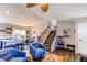 Spacious living room leading to dining, and staircase featuring hardwood floors, providing an ideal space for entertaining at 8463 Wheatgrass Cir, Parker, CO 80134