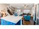 Bright living room featuring island seating and a staircase, with hardwood floors, creating a warm and inviting atmosphere at 8463 Wheatgrass Cir, Parker, CO 80134