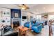 Cozy living room featuring a fireplace, plush armchairs, and an open kitchen concept at 8463 Wheatgrass Cir, Parker, CO 80134