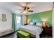 Brightly lit main bedroom with a ceiling fan, large window, and a decorative accent wall at 8463 Wheatgrass Cir, Parker, CO 80134