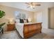 Inviting bedroom with a ceiling fan, soft carpeting, and natural light from the window at 5573 S Lowell Blvd, Littleton, CO 80123