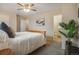 Comfortable carpeted bedroom with ceiling fan, natural light, and adjacent bathroom access at 5573 S Lowell Blvd, Littleton, CO 80123