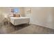Comfortable bedroom featuring neutral carpeting and a plush bed with decorative pillows at 5573 S Lowell Blvd, Littleton, CO 80123