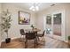 Cozy dining area with a stylish table set, tree decor, and access to the outdoors at 5573 S Lowell Blvd, Littleton, CO 80123