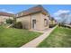 Charming brick home with well-maintained lawn and mature landscaping, showcasing curb appeal at 5573 S Lowell Blvd, Littleton, CO 80123