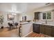 Open kitchen and dining area with a breakfast bar, stainless steel appliances, and wood flooring at 5573 S Lowell Blvd, Littleton, CO 80123