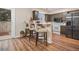 Stylish kitchen featuring modern appliances, countertop seating, and access to the backyard at 5573 S Lowell Blvd, Littleton, CO 80123