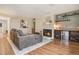 Inviting living room with cozy fireplace, wood floors, and stylish wood shelving and mini fridge at 5573 S Lowell Blvd, Littleton, CO 80123