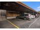 Covered parking area with assigned parking spaces for residents and yellow lines on the pavement at 5573 S Lowell Blvd, Littleton, CO 80123