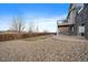 Backyard with a large patio and rock landscaping at 8695 Torrey St, Arvada, CO 80007