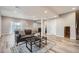 Basement has wood-look flooring, modern furniture, neutral walls, and is brightly lit at 8695 Torrey St, Arvada, CO 80007