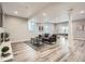 Spacious basement area with wood flooring, a gray sofa, a ping pong table and pot lighting at 8695 Torrey St, Arvada, CO 80007