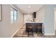Basement kitchenette with bar seating, modern dark cabinets and lots of natural light at 8695 Torrey St, Arvada, CO 80007