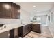Wet bar in basement is convenient with dark cabinets, quartz counters, sink and open space at 8695 Torrey St, Arvada, CO 80007