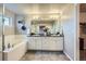 Bathroom with double sinks and a combined tub and shower at 8695 Torrey St, Arvada, CO 80007