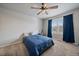 Bedroom features a ceiling fan, carpet floors, a window, and blue curtains at 8695 Torrey St, Arvada, CO 80007