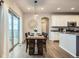 Dining area with wood table adjacent to kitchen, featuring sliding glass doors with access to the deck at 8695 Torrey St, Arvada, CO 80007