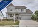 Charming two-story home with a covered front porch and an attached two-car garage at 8695 Torrey St, Arvada, CO 80007