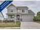 Charming two-story home features a covered porch, well-maintained landscaping, and an attached two-car garage at 8695 Torrey St, Arvada, CO 80007