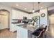 Modern kitchen with white cabinets, a granite island with seating, and stainless steel appliances at 8695 Torrey St, Arvada, CO 80007
