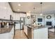 Modern kitchen with white cabinets, a granite island with seating, and stainless steel appliances at 8695 Torrey St, Arvada, CO 80007