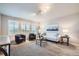 Comfortable living room with big windows with shutter blinds, carpet, and neutral colored walls at 8695 Torrey St, Arvada, CO 80007