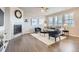 Cozy living room featuring a tiled fireplace, ceiling fan, and hardwood flooring with contemporary furnishings at 8695 Torrey St, Arvada, CO 80007