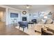 Cozy living room featuring a tiled fireplace, ceiling fan, and hardwood flooring with contemporary furnishings at 8695 Torrey St, Arvada, CO 80007