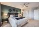 Bright main bedroom featuring an accent wall and carpet with decor, bright windows and neutral colors at 8695 Torrey St, Arvada, CO 80007
